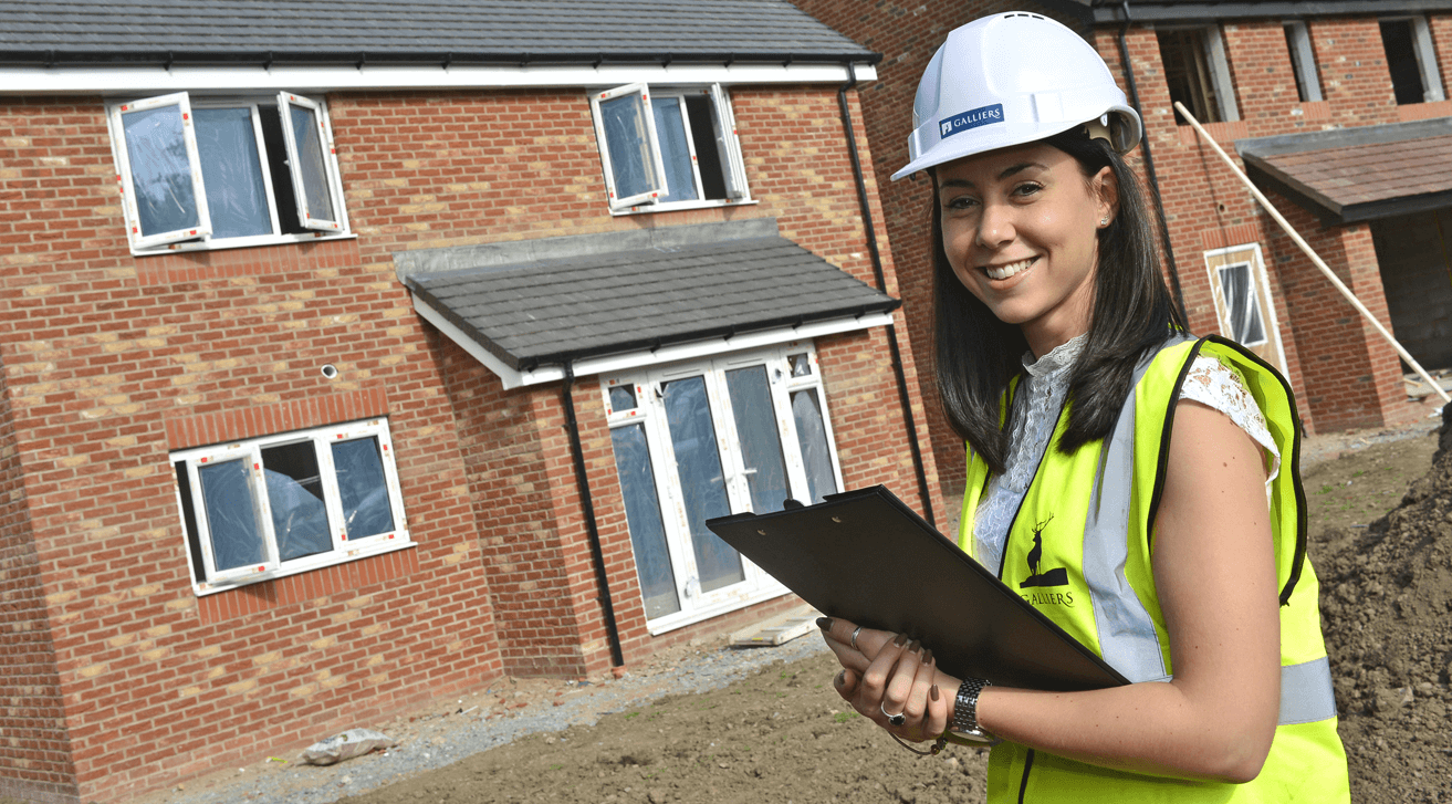 Young student on site with hard hat and clipboard 