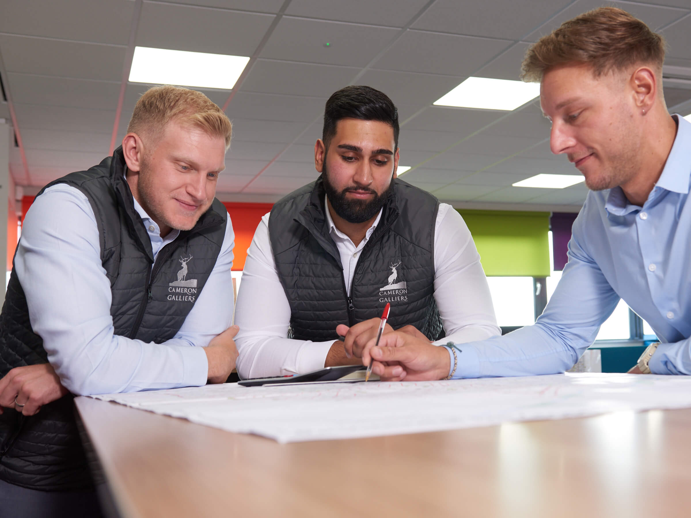 3 graduates in a meeting in the office 