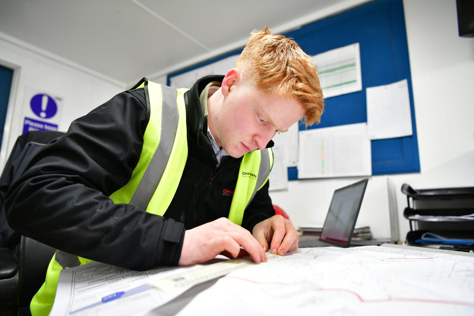 Young apprentice working in the office 