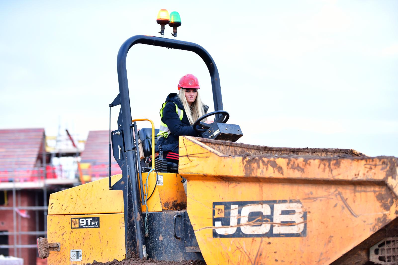Jess Simms driving a construction vehicle on site 